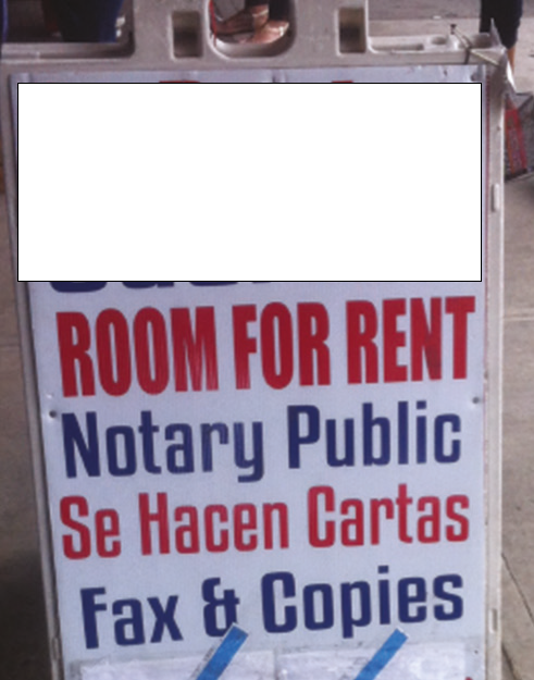 Sandwich board with various ads in English and Spanish (Room for Rent,' etc.) 