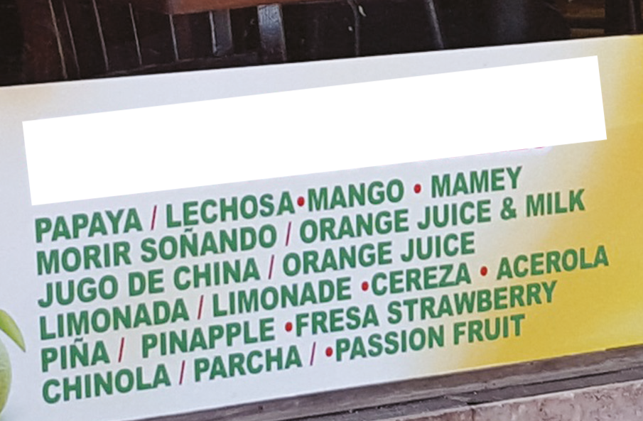 Menu of juices and shakes with flavors listed in both English and Spanish