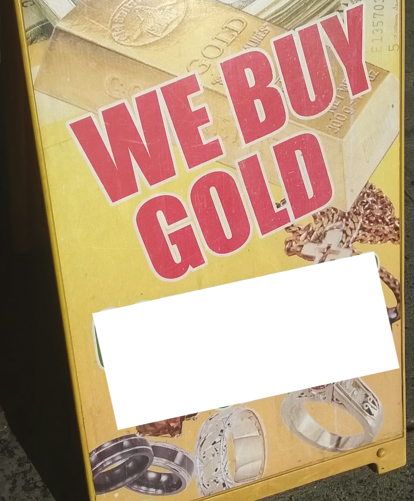 Sandwich board with a We Buy Gold' advertisement 