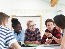 Group of young people having a discussion at a table i